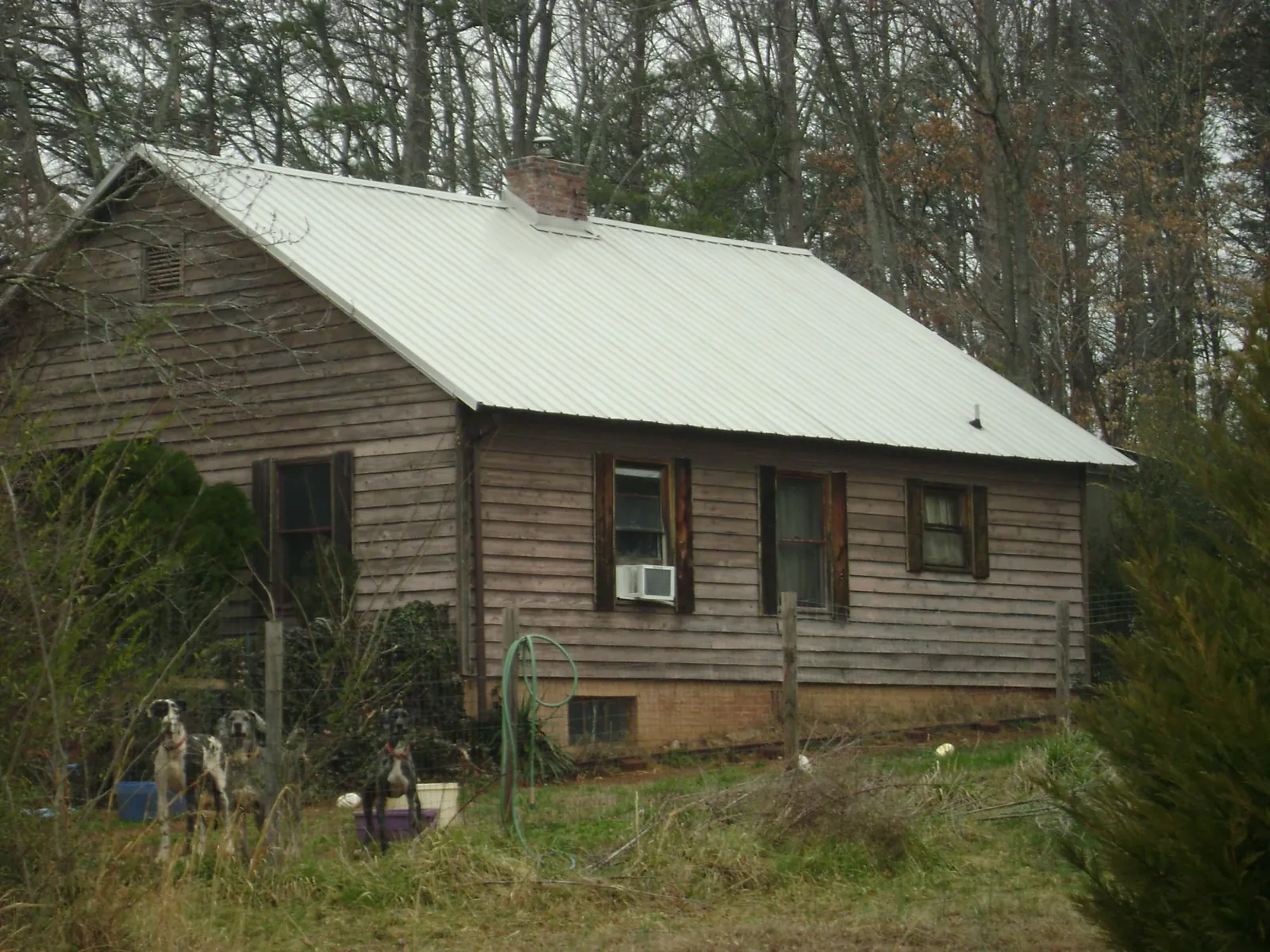 White metal roof on an old wood sided farmhouse, from a Metal Roof Installation job in Marseilles